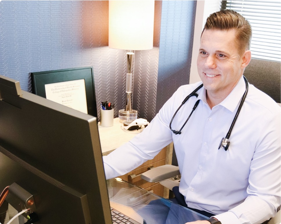 Dr. Carroll watching at his desktop PC.